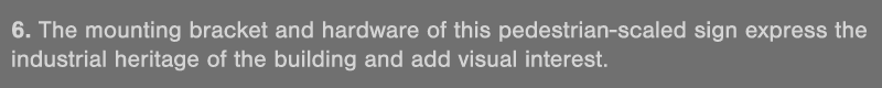 6  The mounting bracket and hardware of this pedestrian-scaled sign express the industrial heritage of the building a   